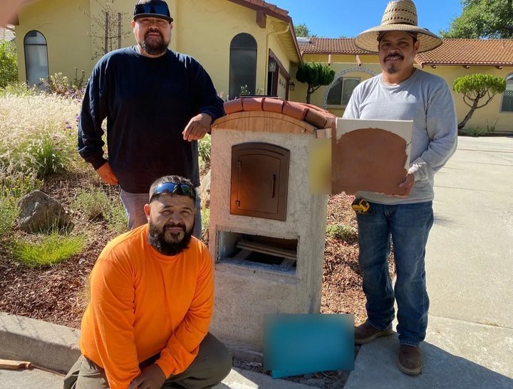 David's crew beside a finished stucco mailbox column with a clay tile cap