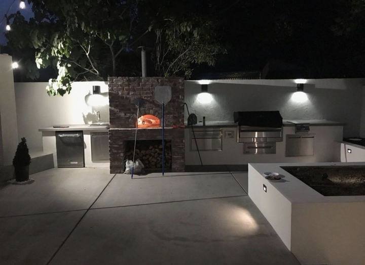 Pizza oven and grill, lit for night